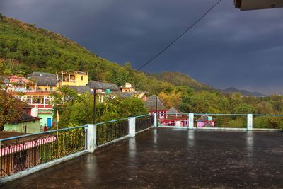 Scenic view of buildings in town against sky