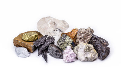 Close-up of stones on rock against white background