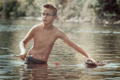 Portrait of boy in river