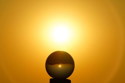 Low angle view of sun against orange sky
