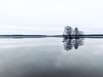 Scenic view of lake against sky during winter