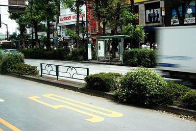 Road sign by street in city