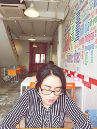 Young woman sitting in corridor