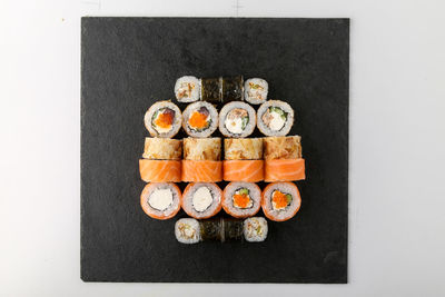 Directly above shot of sushi served on white background