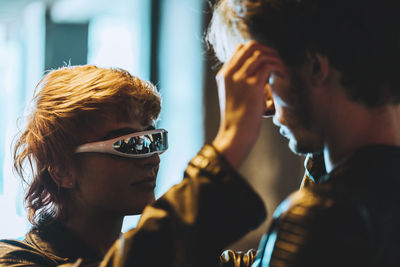 Young woman with smart glasses looking at boyfriend