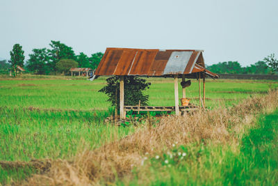 Barn on field against clear sky