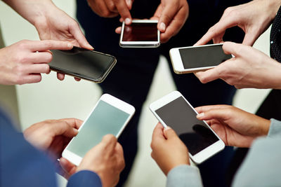 Midsection of woman using mobile phone