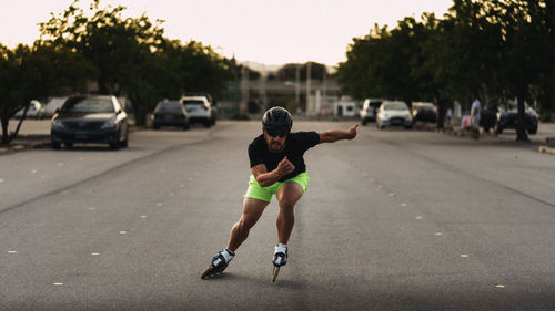 Full length of man inline skating on road against sky