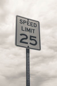 Low angle view of road sign against sky