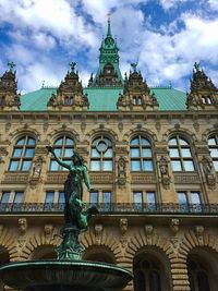 Low angle view of building against cloudy sky