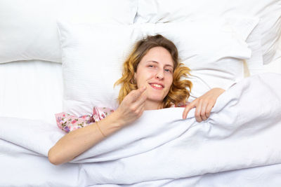 Happy woman lying down on bed