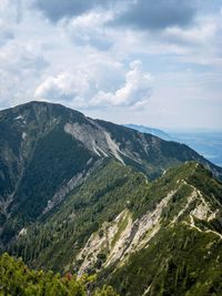 Scenic view of valley and mountains against sky