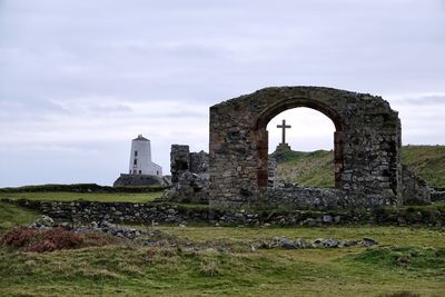 Built structure on field against sky