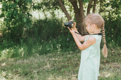 Full length of child photographing through camera