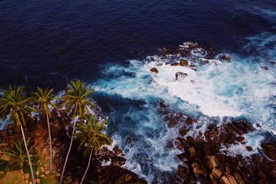 High angle view of waves splashing on shore