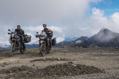 Couple on touring motorbikes at the pass of abra de malaga (4316 m)