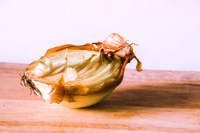 Close-up of bananas on table against white background