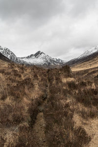 Scenic view of snow covered mountains against sky