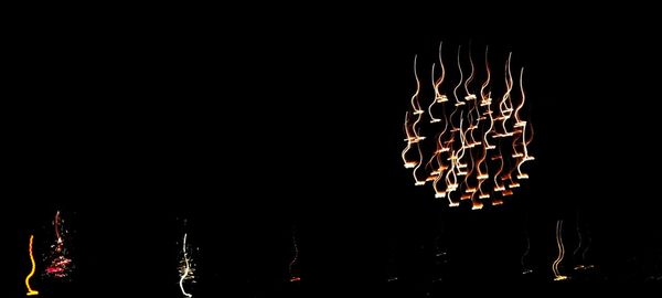 Low angle view of illuminated lights at night