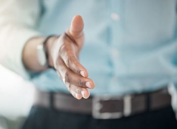 Midsection of couple holding hands