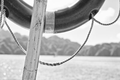 Close-up of rope tied to chain on playground