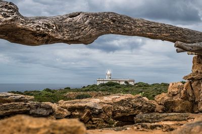 Rocks by sea against sky
