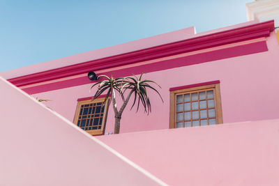 Low angle view of pink house against clear sky