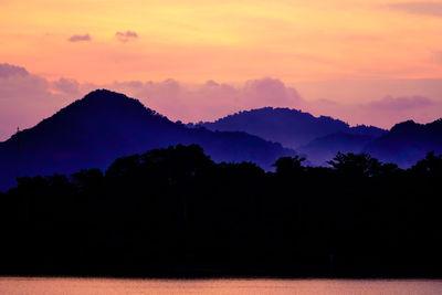 Scenic view of silhouette mountains against sky during sunset