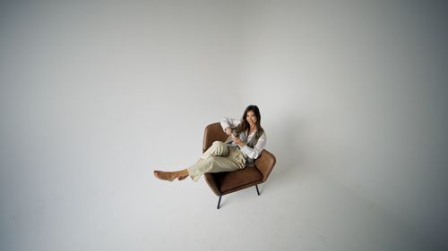 Young woman sitting on chair
