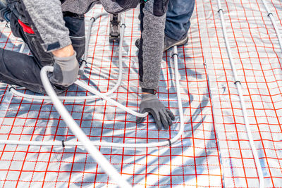 Low section of man holding rope