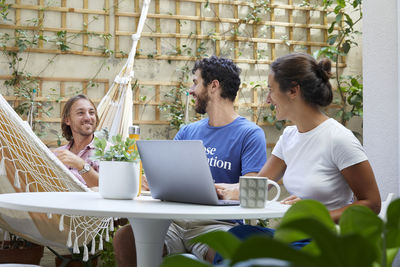 Young woman using laptop while sitting at home