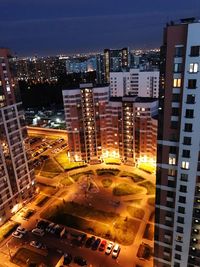 High angle view of illuminated buildings in city at night