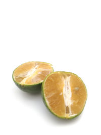 Close-up of orange fruit against white background