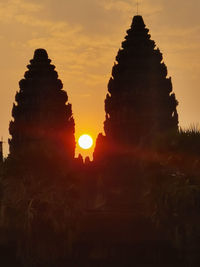 Silhouette temple against sky during sunset