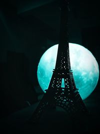 Low angle view of illuminated lighting equipment at night