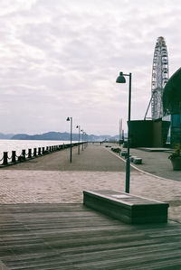 Pier on beach against sky