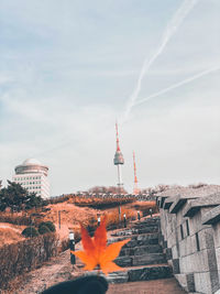 Tower amidst buildings in city against sky