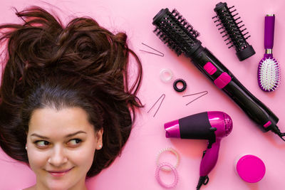 Woman with brown hair by personal accessories on table