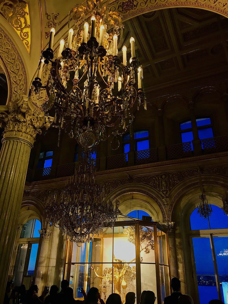 LOW ANGLE VIEW OF ILLUMINATED CHANDELIER IN A BUILDING