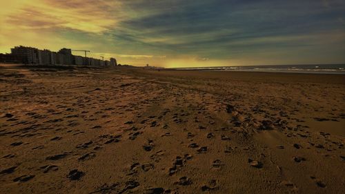 Scenic view of beach against sky during sunset