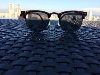 Close-up of sunglasses against sky