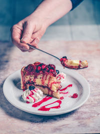 Cropped hand of woman holding food