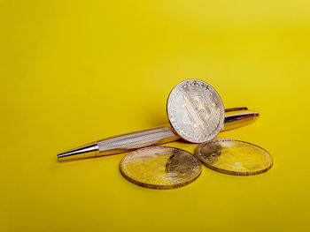 Close-up of electric lamp against yellow background
