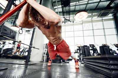 Muscular man exercising at gym