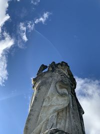 Low angle view of statue against blue sky