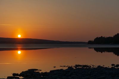 Scenic view of lake against romantic sky at sunset