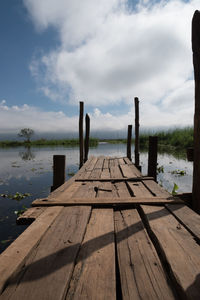 Pier over lake against sky