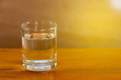 Close-up of water in drinking glass on wooden table