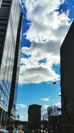 Low angle view of buildings against cloudy sky