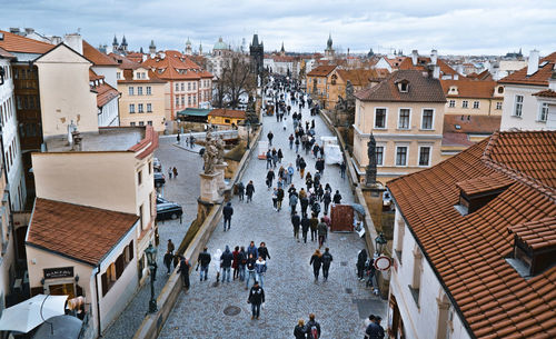 High angle view of people on street amidst buildings in city